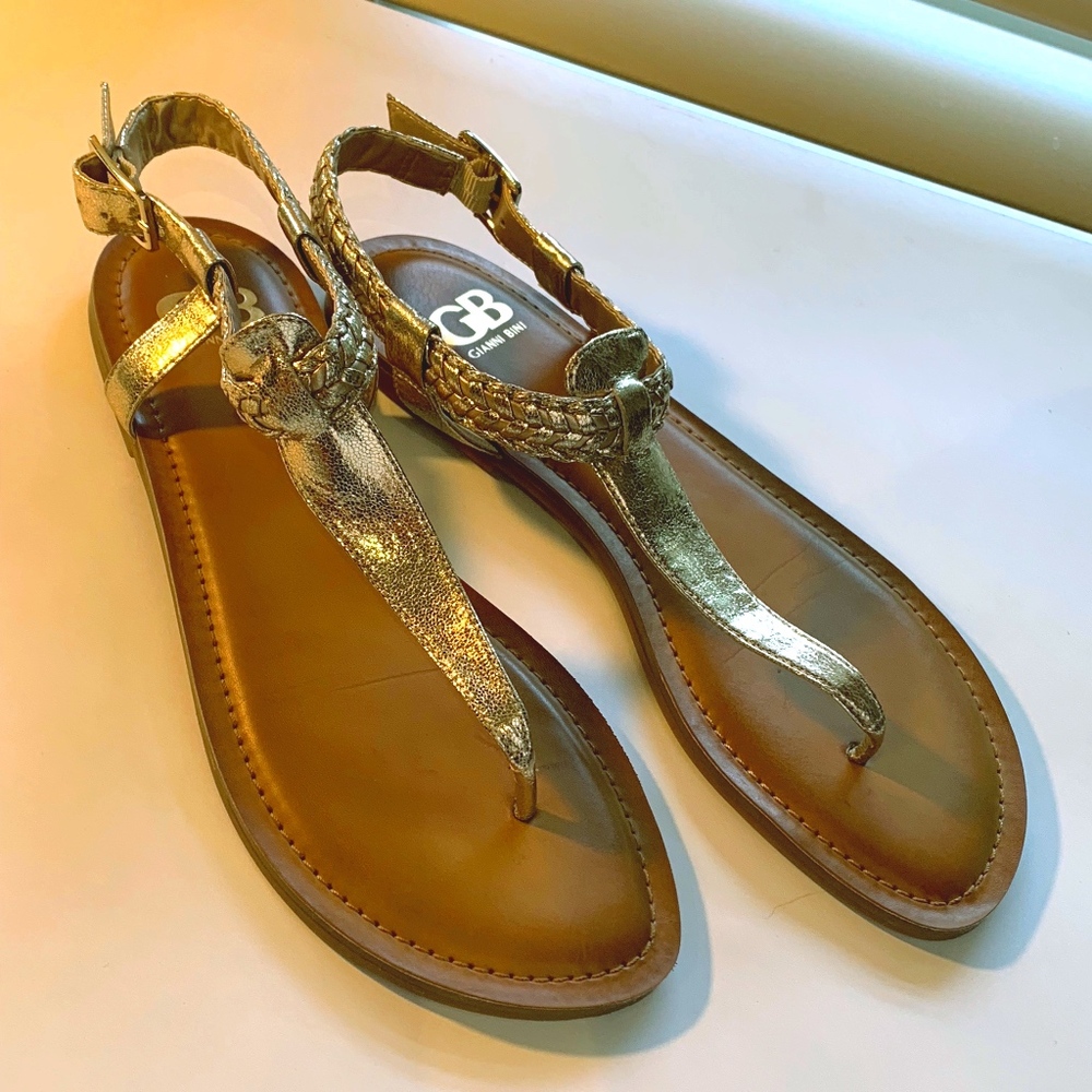 Gold metallic thong flat sandals by Gianni Bini